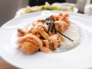 A plate of homemade Japanese Chicken Karaage served with Mentai sauce and white rice