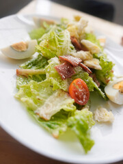 homemade Caesar Salad with crisp romaine lettuce, eggs, smoked beef, crunchy croutons, parmesan cheese, and a light Caesar dressing