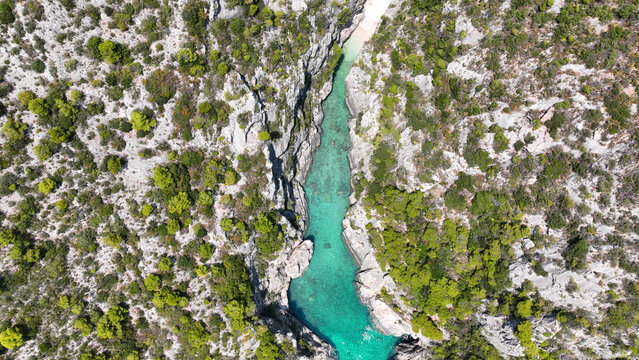 Aerial drone photo of of Porto Stenitis famous fjord shaped bay with crystal clear turquoise sea and small beach  ideal for snorkeling visited by small tourist boats, Zakinthos island, Ionian, Greece