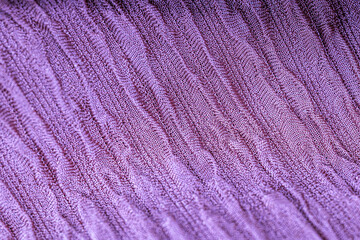 Macro of texture of purple color jacquard fabric with pattern