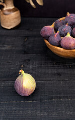 Fresh Figs in Wooden Bowls with Dark Rustic Background and Vase Decor