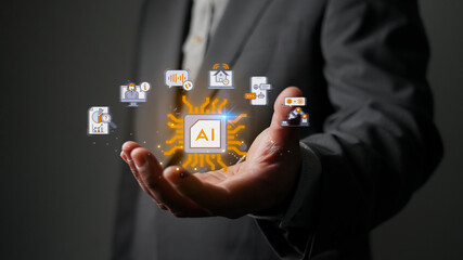 Businessman holding a glowing AI microchip icon. Concept of artificial intelligence, machine learning, business automation, big data analysis, and future technology innovation.