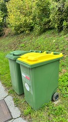 Green garbage bin in front of the house.Public trash on the side of the road.Infectious control concept.
