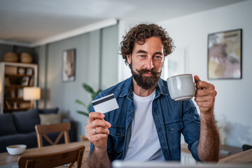 Man shopping online using credit card and coffee
