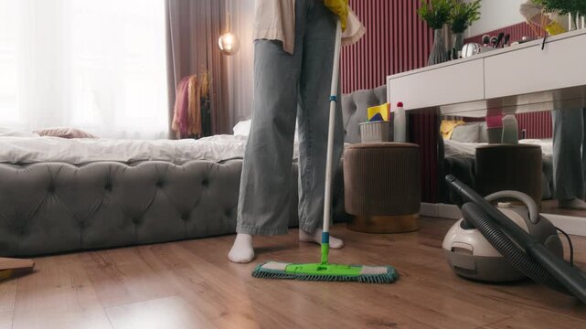 Calm Caucasian woman female washing dirty dusty floor covering at home bedroom cleaning concentrated wash apartment girl hygienic maintenance homeowner housewife housekeeping with mop duties cleanup