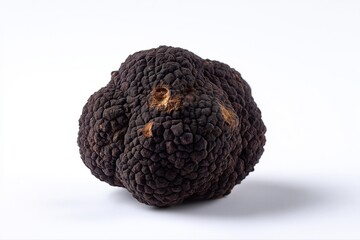 Fresh black truffle on white surface