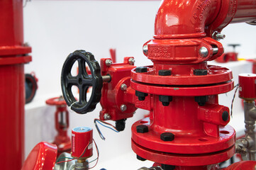 The picture shows a red fire hose with a black handle