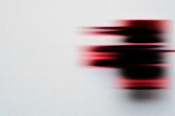 Abstract modern art featuring blurred red shapes on a clean white background, creating minimal futuristic motion and digital design style.