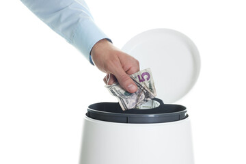 Man throwing money into trash bin on white background, closeup