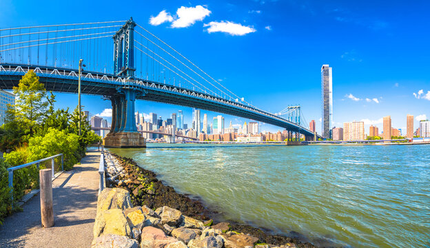New York City epic skyline and Manhattan bridge view from Brooklyn riverfront