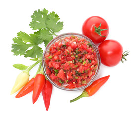Delicious salsa sauce in bowl and ingredients isolated on white, top view