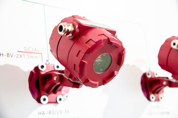 Three red infrared detection devices equipped with temperature detection lenses are installed on a white background.