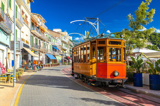Island of Mallorca. Colorful  tramway links the inland town of Soller to Port de Soller, running along the beach-side road.