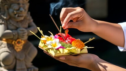 Offering Ceremony with Incense and Flowers Near a Stone Statue in Bali