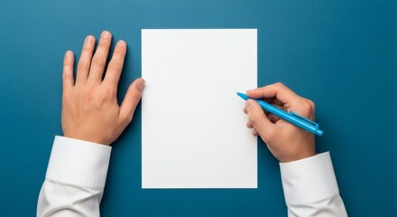 Beginning Hands poised above blank paper with blue pen in hand, and ready to create.