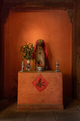 The stone statue of dog at the entrance of the Japanese Covered Bridge in Hoi An, Vietnam