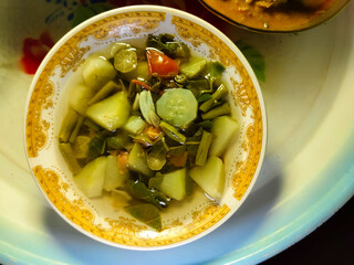 close up of a bowl of clear vegetable soup