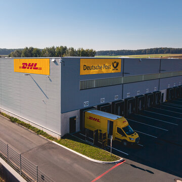 View of the Deutsche Post, DHL distribution center with the delivery vehicle being loaded