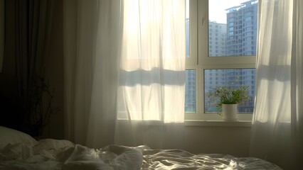 Cozy bedroom with soft light and curtain near window