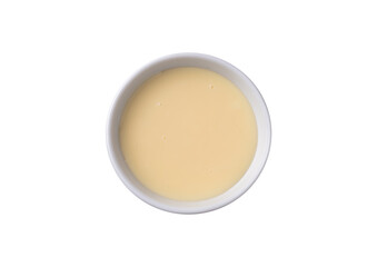 Condensed milk in a bowl isolated over white background
