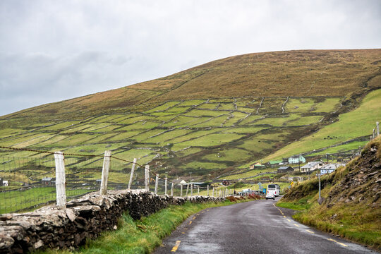 Narrow country road through the countryside on an overcast day, Dingle Peninsula, County Kerry, Ireland