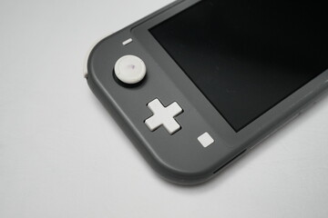Nintendo Switch Lite Handheld Console in Grey on White Surface