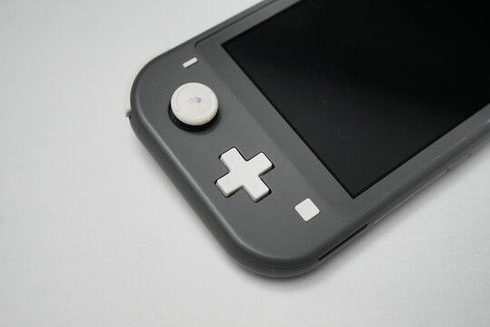 Nintendo Switch Lite Handheld Console in Grey on White Surface