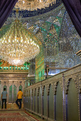 Ornate chandelier illuminates a mirrored hall