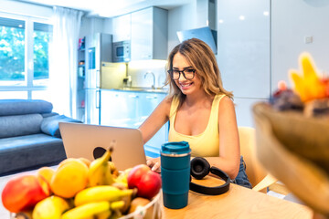 Freelancer working from home enjoying modern lifestyle with laptop and healthy food