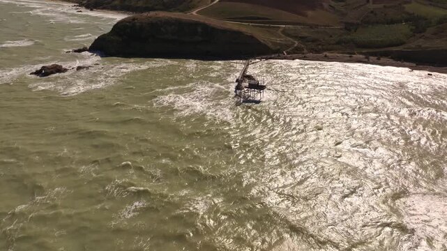 Drone flight over sunlit cliffs and calm Adriatic waters.