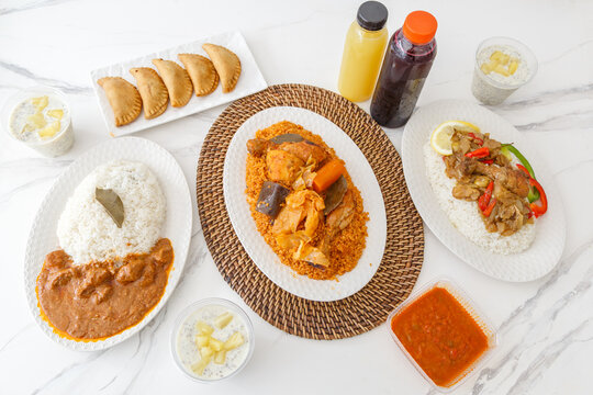 Pr&eacute;sentation de plats africains (mets embl&eacute;matiques comme le Maf&eacute;, le Yassa, le Thiep, les Pastels, le Riz au poisson) &ndash; sp&eacute;cialit&eacute;s s&eacute;n&eacute;galaises et maliennes vues du dessus (vue &agrave; 90&deg;)