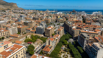 Obraz premium Aerial view of Politeama Theatre, complete name Teatro Politeama Garibaldi. It is a theatre of Palermo, Sicliy, Italy. In background is the port of the city.