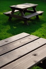 Fototapeta premium Teenage hangout spot, empty lawn chairs under dappled sunlight, overgrown vines, rustic outdoor table A rustic wooden picnic table and two empty, weathered metal lawn chairs situated in a slightly