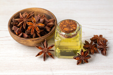 Star anise essential oil on bottle on wooden table. Alternative medicine