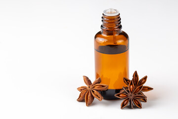Star anise essential oil on bottle on wooden table. Alternative medicine
