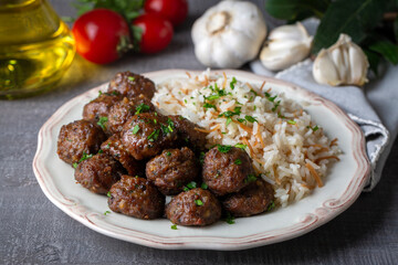 Round shaped balls of dry meatballs and french fries. Turkish name; kuru kofte ve patates