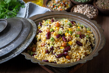 Bulgur pilaf with legumes; with peas, beans and corn kernels.