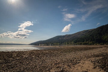 A sunny autumnal HDR image of an empty Ardentinny beach in Finart Bay near Dunoon, Argyll and Bute, Scotland.