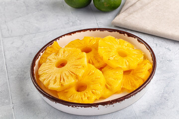 Sweet canned pineapple slices in syrope