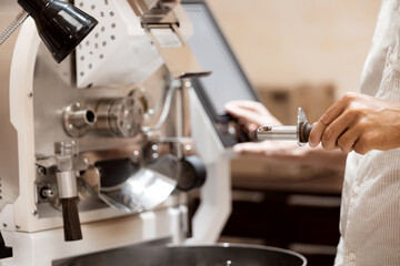 Professional coffee bean roasting process with specialized equipment, owner small business