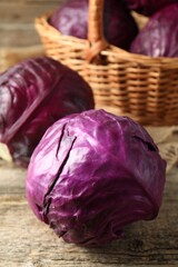 Fototapeta premium Whole ripe red cabbages on wooden table, closeup