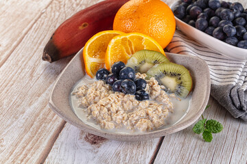 Oats porridge with blueberry, kiwi and orange