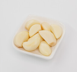 Fresh Garlic Cloves in White Bowl Ready for Cooking, Flavorful Dishes, and Everyday Recipes