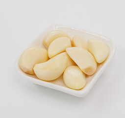 Fresh Garlic Cloves in White Bowl Ready for Cooking, Flavorful Dishes, and Everyday Recipes