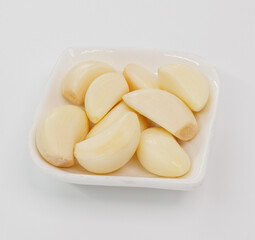 Fresh Garlic Cloves in White Bowl Ready for Cooking, Flavorful Dishes, and Everyday Recipes
