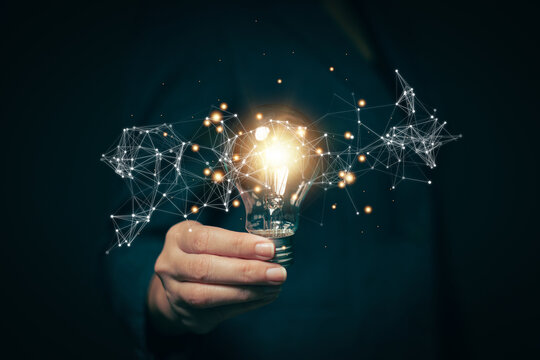 Glowing light bulb in hand, idea search concept Creativity from information trade in the internet world, marketing, business ideas and target groups.