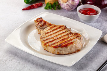 Tasty hot grilled bone steak served sauce