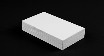 A stack of white business cards is displayed against a stark black background