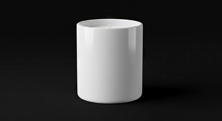A white candle in a cylindrical container rests on a dark surface