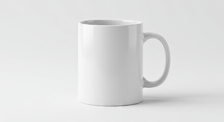 Fototapeta premium A white ceramic mug sits centered against a bright white background handle to the right